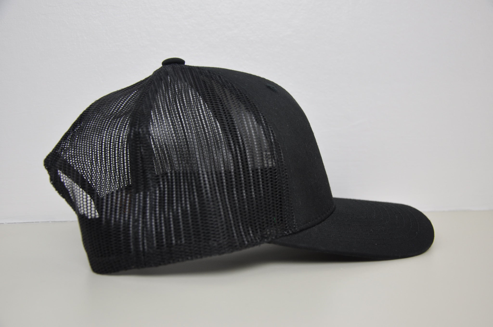 Black retro trucker X White logo